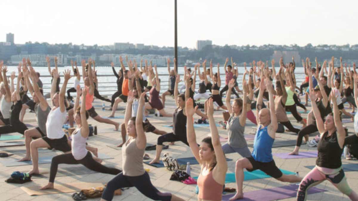 Yoga Plus Magazine - Yoga Reaches Out - People doing yoga at Gillette stadium